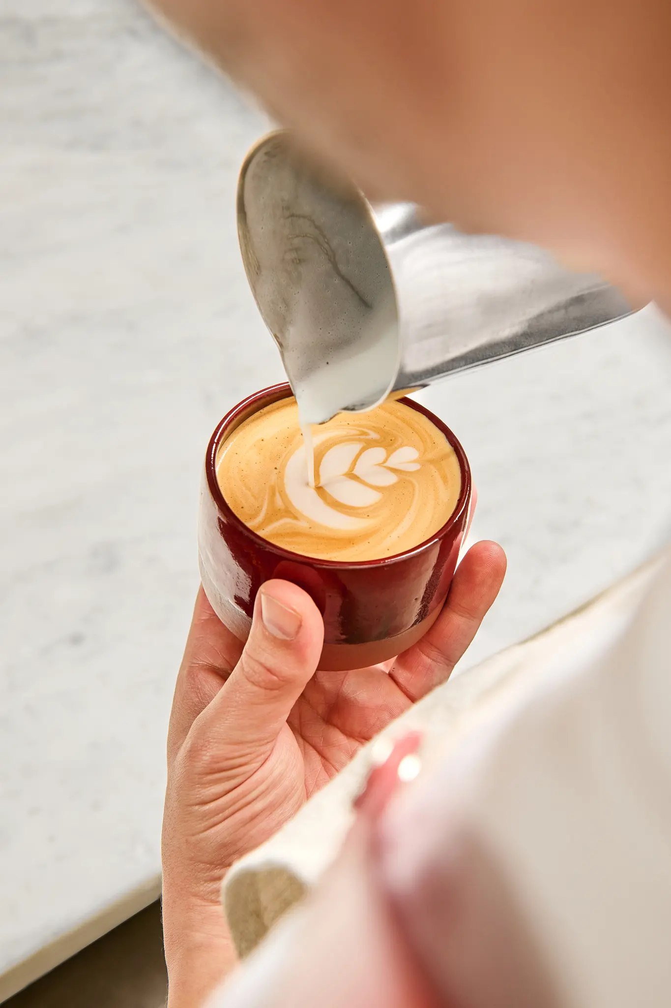 Close-up of latte art – a hand-crafted coffee with a delicate milk-foam heart.